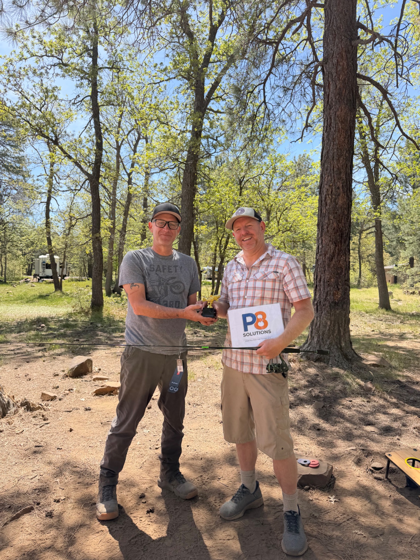 Jon Cordoba presenting the 2026 fishing trophy to Erik Anderson
